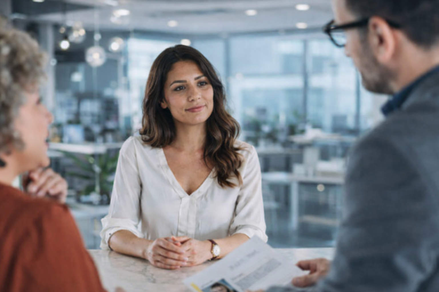 Recruitment team reviewing AI-generated candidate readiness scores and role alignment insights on a laptop during a structured hiring evaluation meeting.