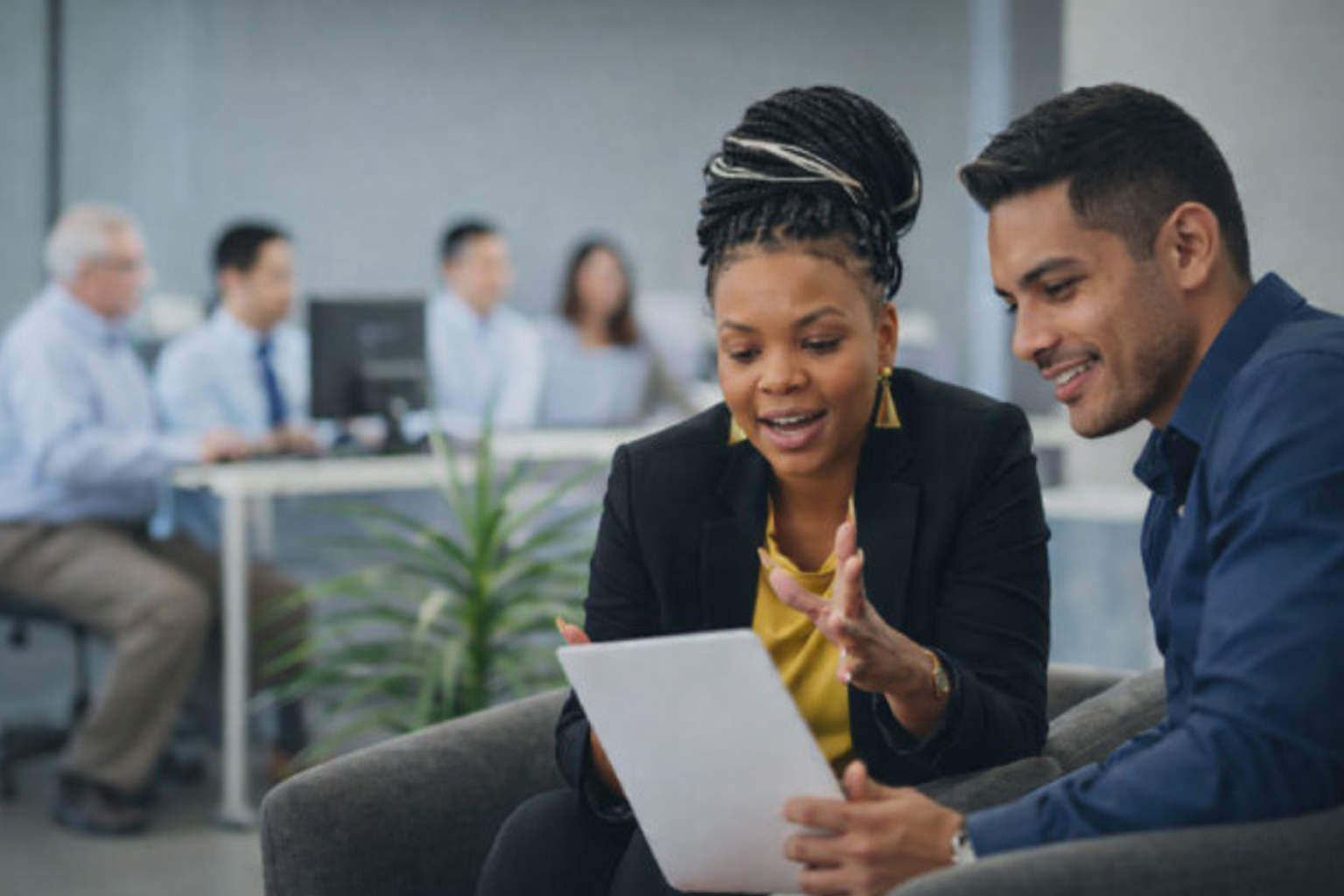 Adult learners and job seekers using laptops in a workforce training center, receiving AI-supported career guidance and employment readiness support.